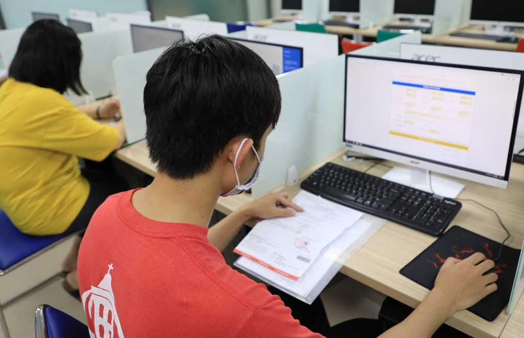 Close-up of hands verifying multiple certificates with a digital scanner